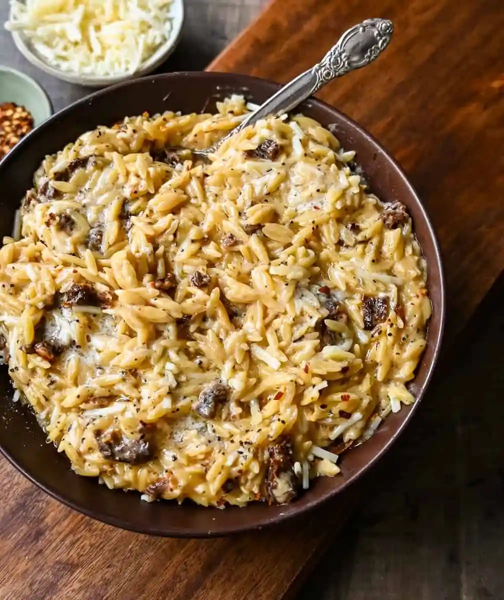 Boursin Cheese Sundried Tomato Orzo. A quick and easy one pot side dish made with orzo pasta in a creamy boursin cheese parmesan sundried tomato sauce.