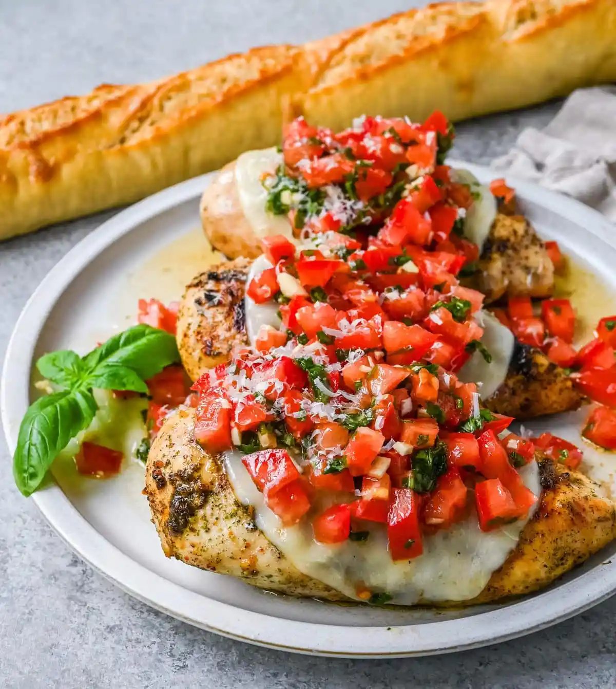 Bruschetta Grilled Chicken combines tender Italian grilled chicken breasts with juicy, garlicky tomato bruschetta, creamy melted mozzarella cheese, and a drizzle of balsamic glaze.
