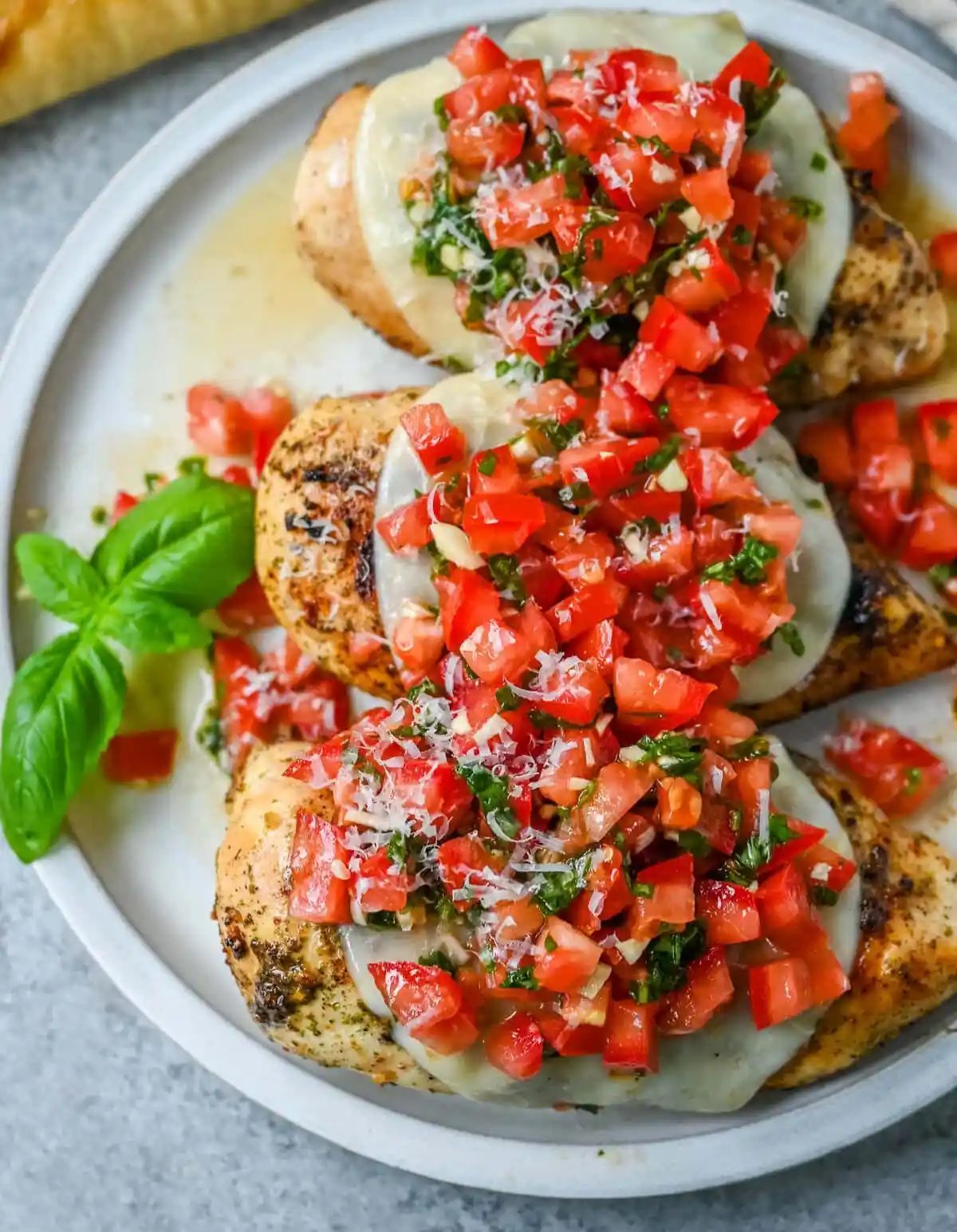 Bruschetta Grilled Chicken combines tender Italian grilled chicken breasts with juicy, garlicky tomato bruschetta, creamy melted mozzarella cheese, and a drizzle of balsamic glaze.