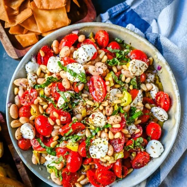 This Italian Cowboy Caviar is a fresh, flavorful twist on the viral cowboy caviar made with juicy tomatoes, creamy mozzarella pearls, tender white beans, pepperoncinis, and basil for a Mediterranean-inspired dip. This easy Italian appetizer comes together in minutes and is perfect for holiday parties, snacking, or meal prep.