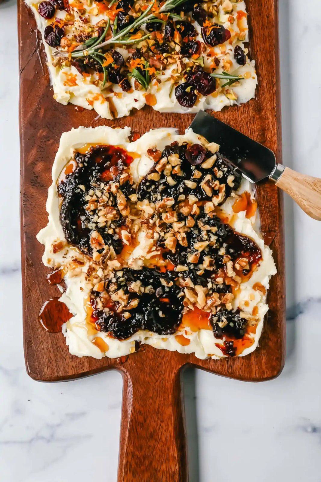 A Butter Board with fresh butter is spread onto a board and topped with an assortment of toppings and served with warm bread. This Butter Board with Toppings is such a fun appetizer for a party!