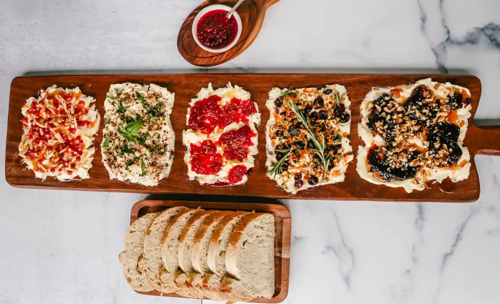 A Butter Board with fresh butter is spread onto a board and topped with an assortment of toppings and served with warm bread. This Butter Board with Toppings is such a fun appetizer for a party!