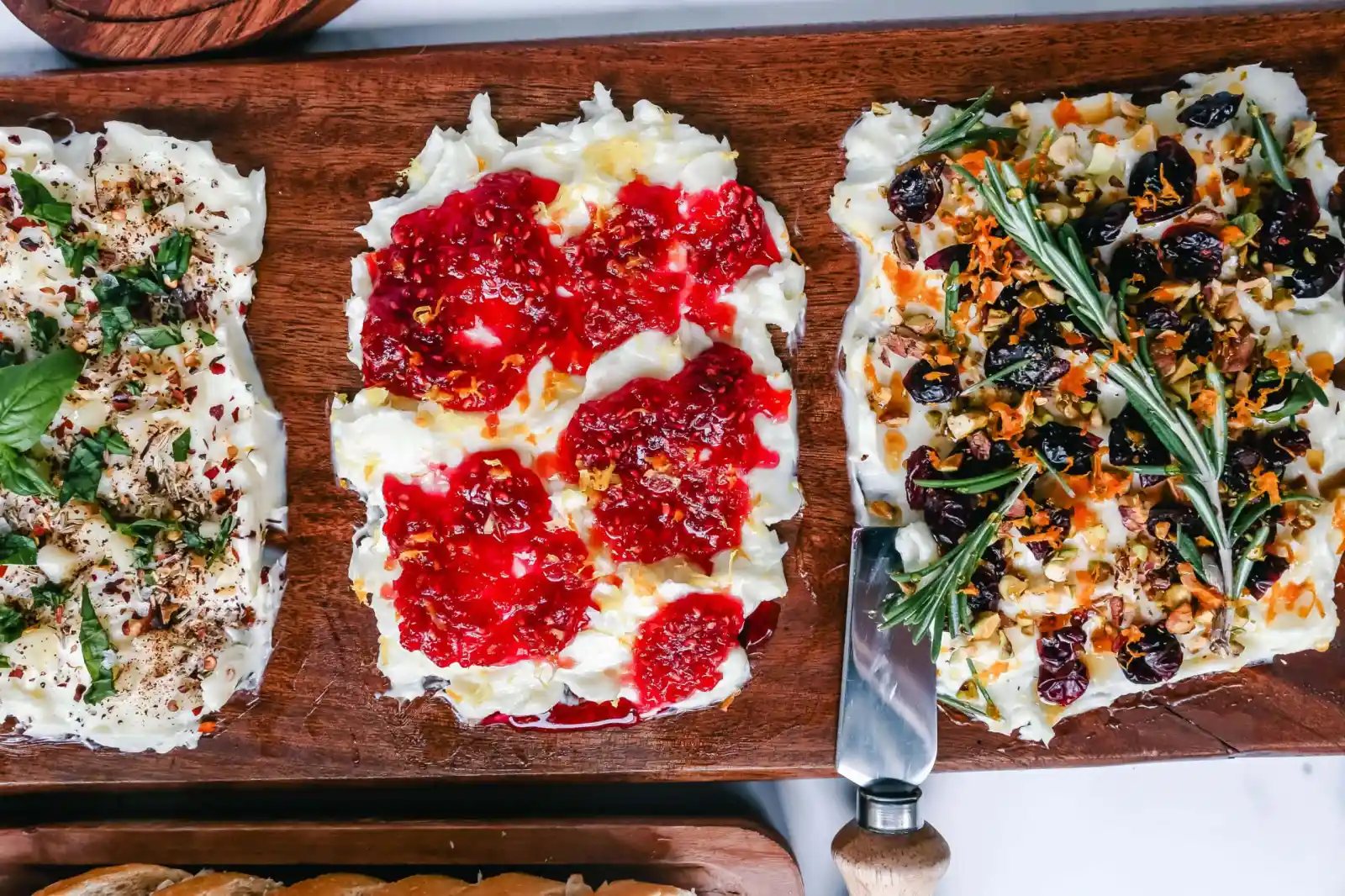 A Butter Board with fresh butter is spread onto a board and topped with an assortment of toppings and served with warm bread. This Butter Board with Toppings is such a fun appetizer for a party!