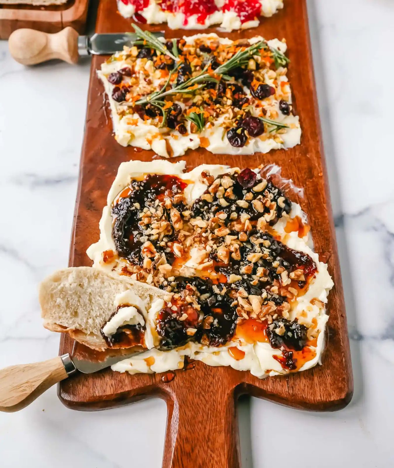 A Butter Board with fresh butter is spread onto a board and topped with an assortment of toppings and served with warm bread. This Butter Board with Toppings is such a fun appetizer for a party!