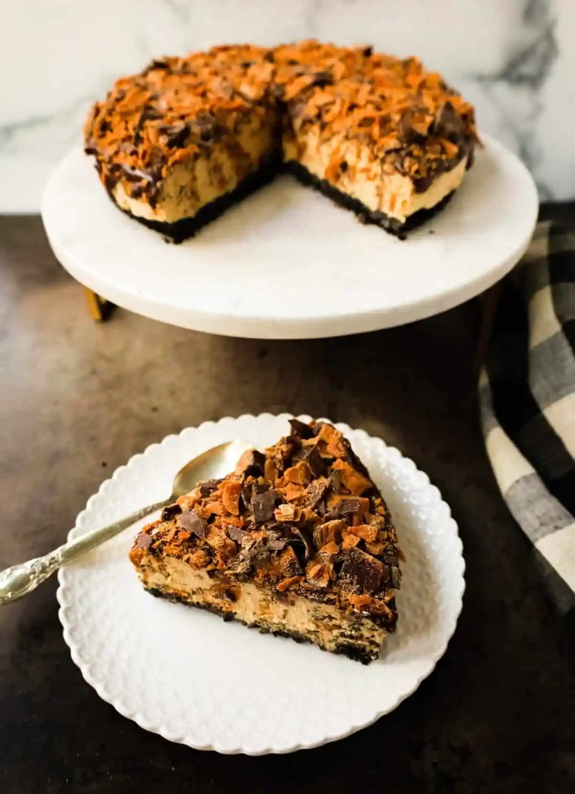 No-Bake Chocolate Peanut Butter Butterfinger Pie with a chocolate OREO crust, creamy peanut butter filling with Butterfinger candy bars, chocolate ganache, and topped with fresh whipped cream and Butterfinger. The best creamy Butterfinger pie recipe!
