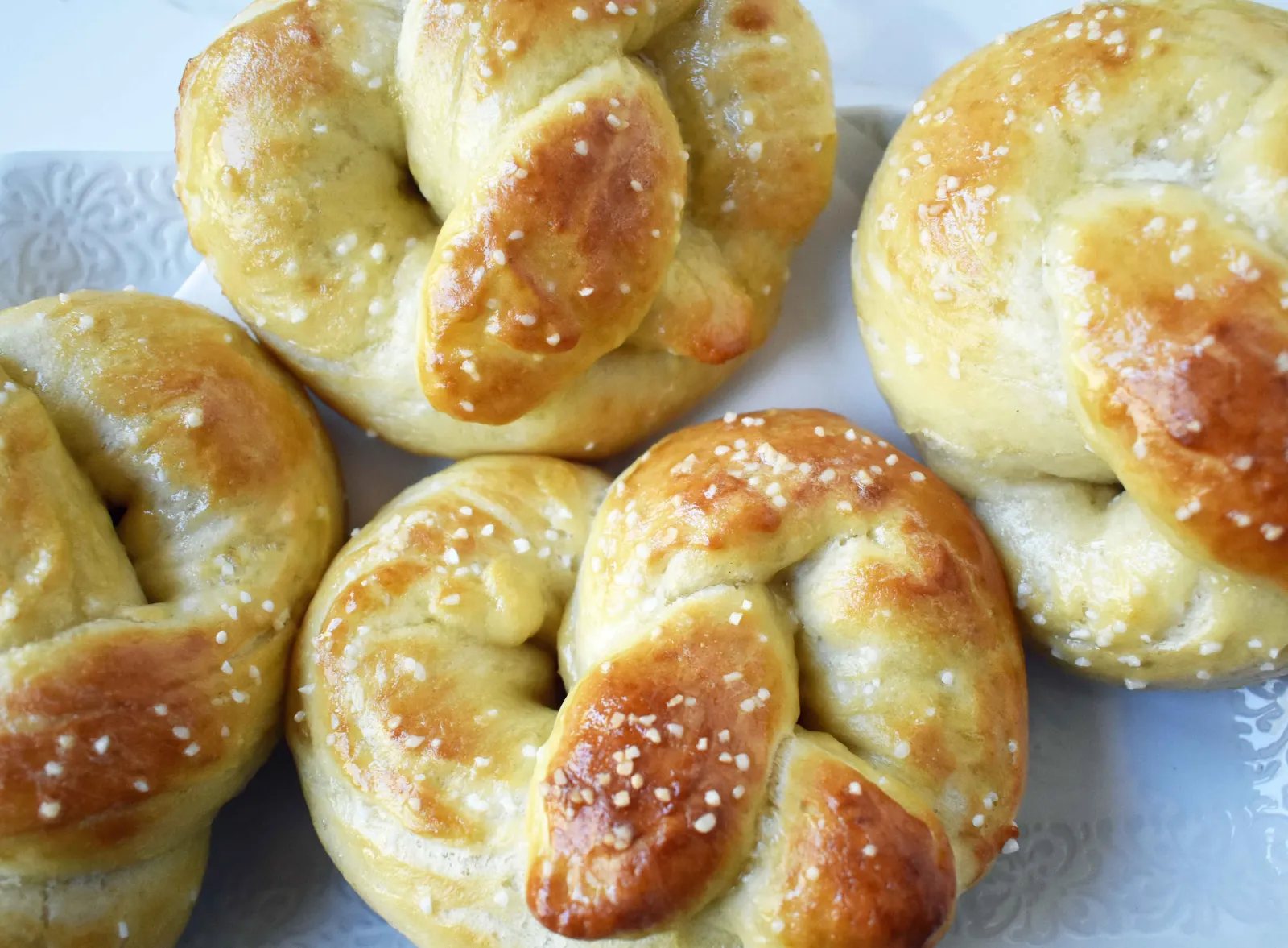 Buttery Soft Pretzels. Homemade, made from scratch soft pretzels. Buttery, soft, and fluffy pretzels with melted butter and coarse salt. Super easy to make! www.modernhoney.com