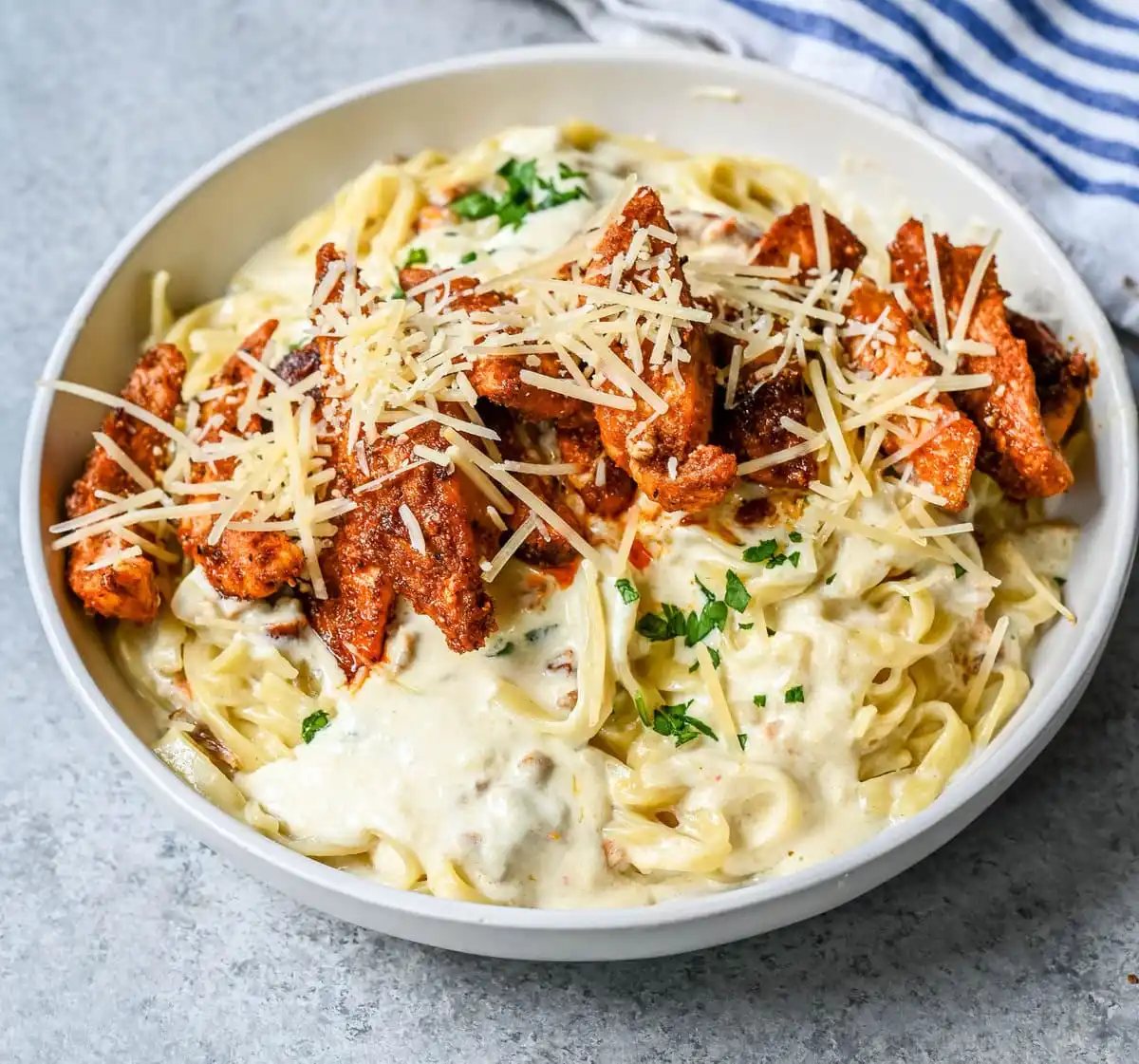 Cajun Chicken Alfredo is the ultimate comfort food with a spicy twist — tender blackened chicken, tossed in a silky Parmesan cream sauce over perfectly cooked pasta. Whether you're cooking for a weeknight dinner or a crowd, this dish delivers big time in flavor.