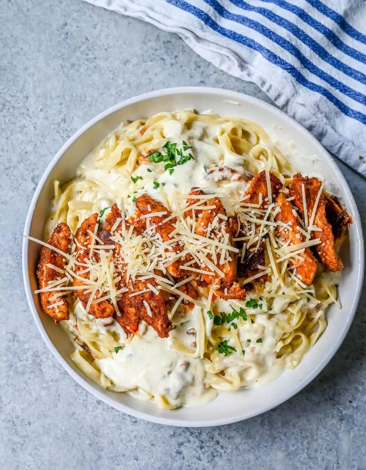 Cajun Chicken Alfredo is the ultimate comfort food with a spicy twist — tender blackened chicken, tossed in a silky Parmesan cream sauce over perfectly cooked pasta. Whether you're cooking for a weeknight dinner or a crowd, this dish delivers big time in flavor.