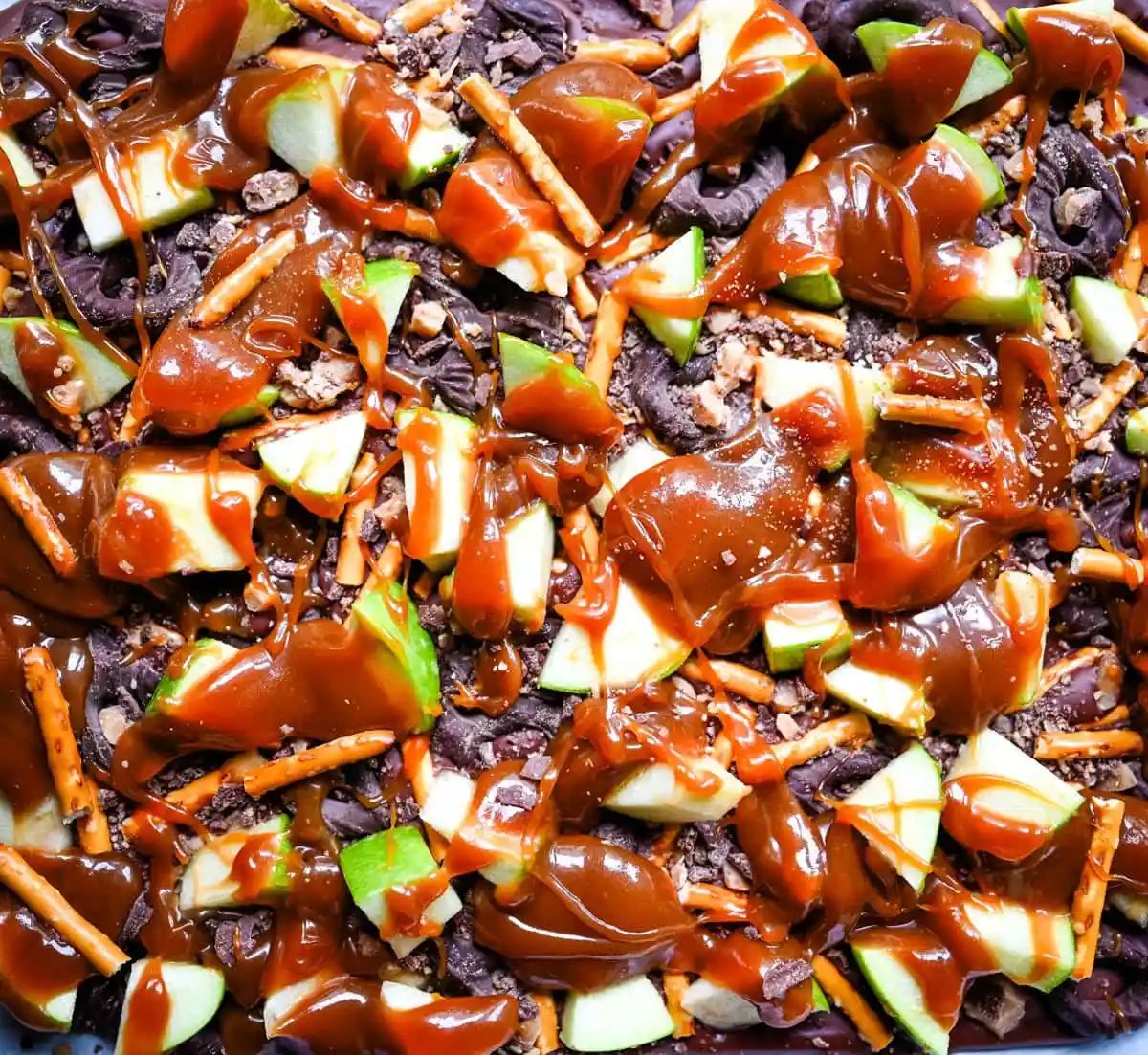 This Caramel Apple Bark is an easy no-bake Fall treat and made with fresh apples, buttery caramel, crunchy pretzels, and rich chocolate. This quick and easy Fall dessert is absolutely delicious and a crowd favorite!