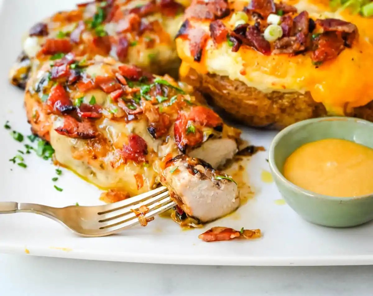 Cheesy Bacon Smothered Chicken. This juicy, marinated grilled chicken breast is smothered with honey mustard sauce, melted cheese, and crispy bacon. To make it extra flavorful, add caramelized onions or mushrooms. You may know this as the famous Alice Springs Chicken from Outback Steakhouse but you can make it at home.