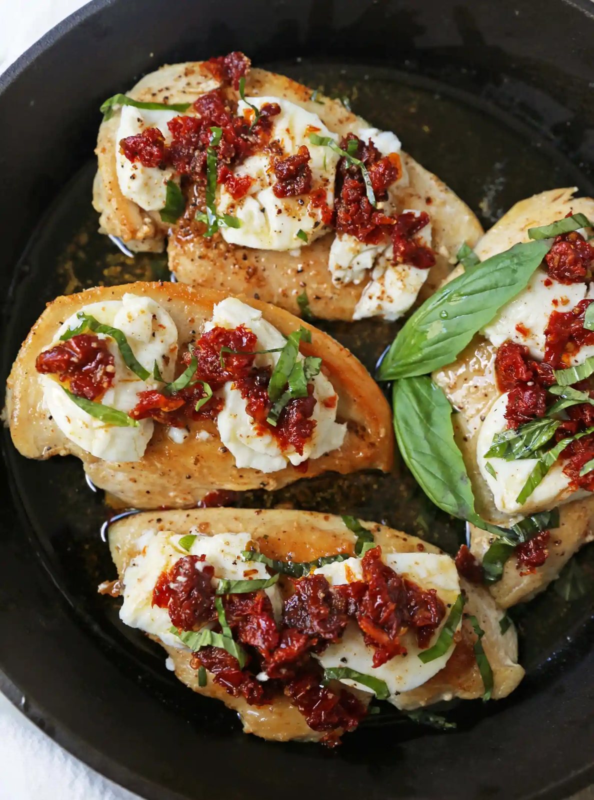 Chicken Bryan. Grilled chicken with a basil lemon butter sauce topped with sundried tomatoes and creamy goat cheese. A Carrabba's favorite! www.modernhoney.com #chickenbryan #carrabbas #chicken