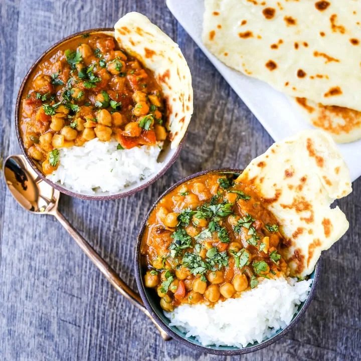Coconut Chickpea Curry A rich coconut curry broth with onion, garlic, ginger, Indian spices in coconut milk and tossed with chickpeas. Flavorful vegan meal and you won't even miss the meat! www.modernhoney.com #vegan #curry #indianfood #vegancurry #chickpeacurry