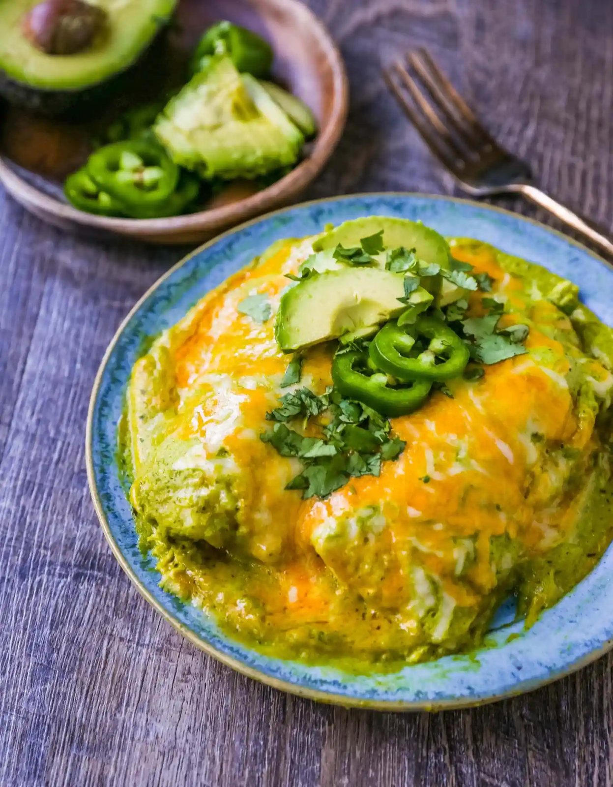 Chicken Enchiladas Suizas Creamy chicken enchiladas in a homemade tomatillo poblano sauce and baked with Mexican cheeses until bubbly.