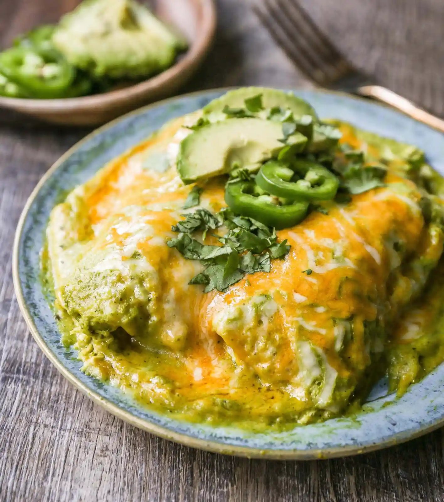 Chicken Enchiladas Suizas Creamy chicken enchiladas in a homemade tomatillo poblano sauce and baked with Mexican cheeses until bubbly.