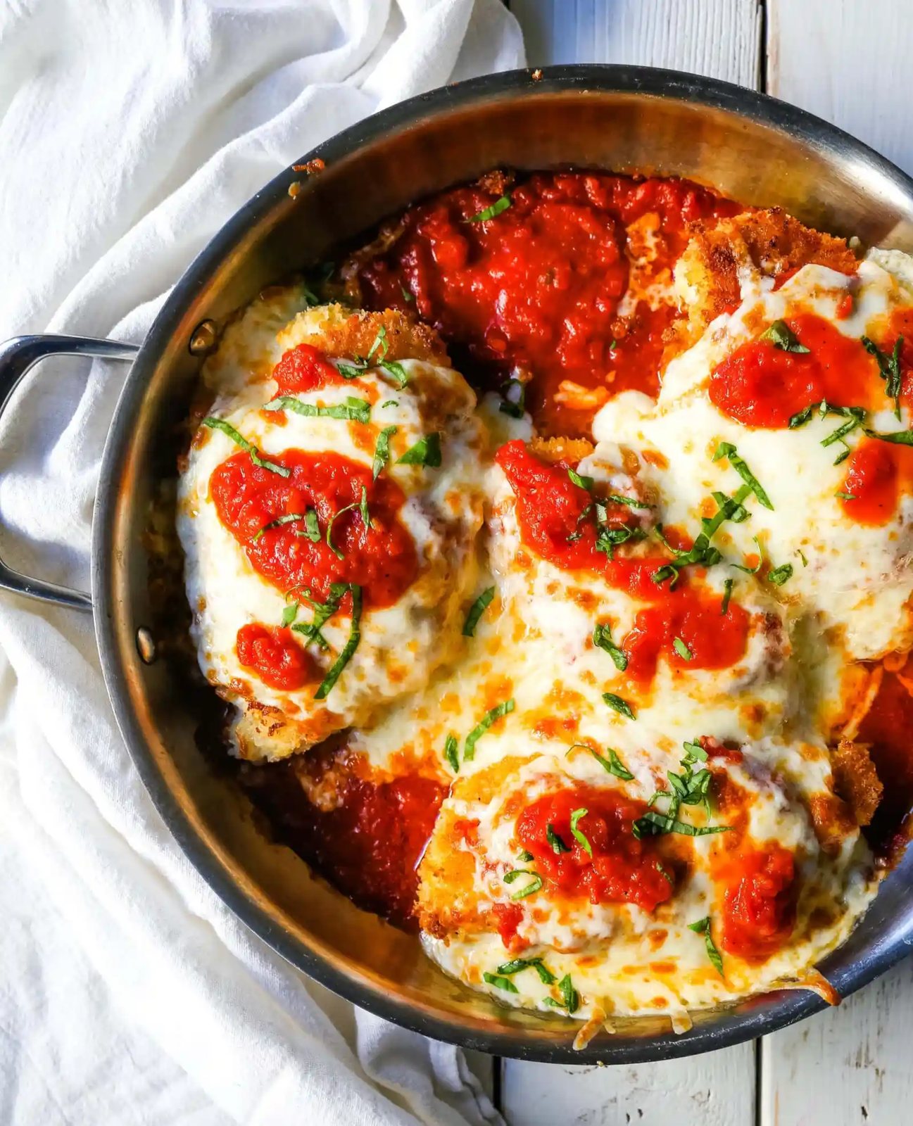 Chicken Parmesan. Panko-crusted chicken breast topped with homemade marinara sauce, melted whole milk mozzarella, and parmesan cheeses and baked until golden and bubbly. www.modernhoney.com #chicken #chickenparmesan #italian