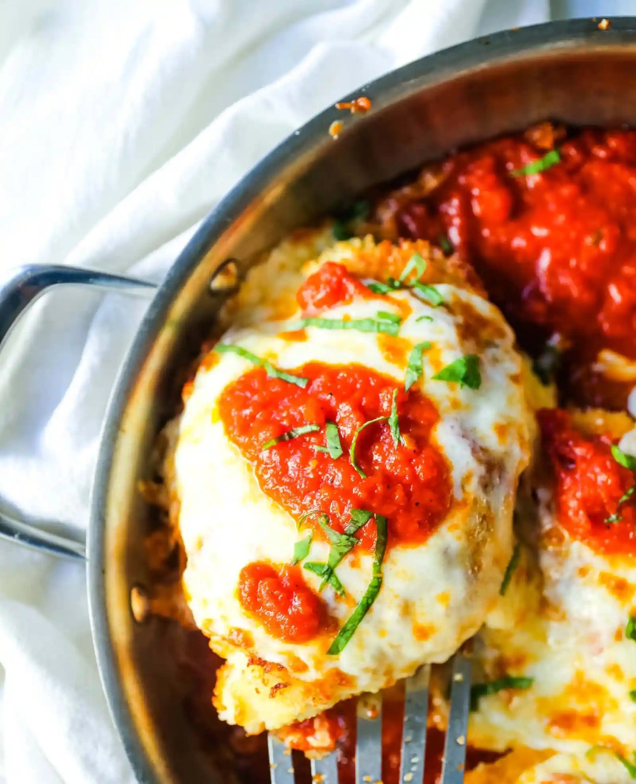 Chicken Parmesan. Panko-crusted chicken breast topped with homemade marinara sauce, melted whole milk mozzarella, and parmesan cheeses and baked until golden and bubbly. www.modernhoney.com #chicken #chickenparmesan #italian