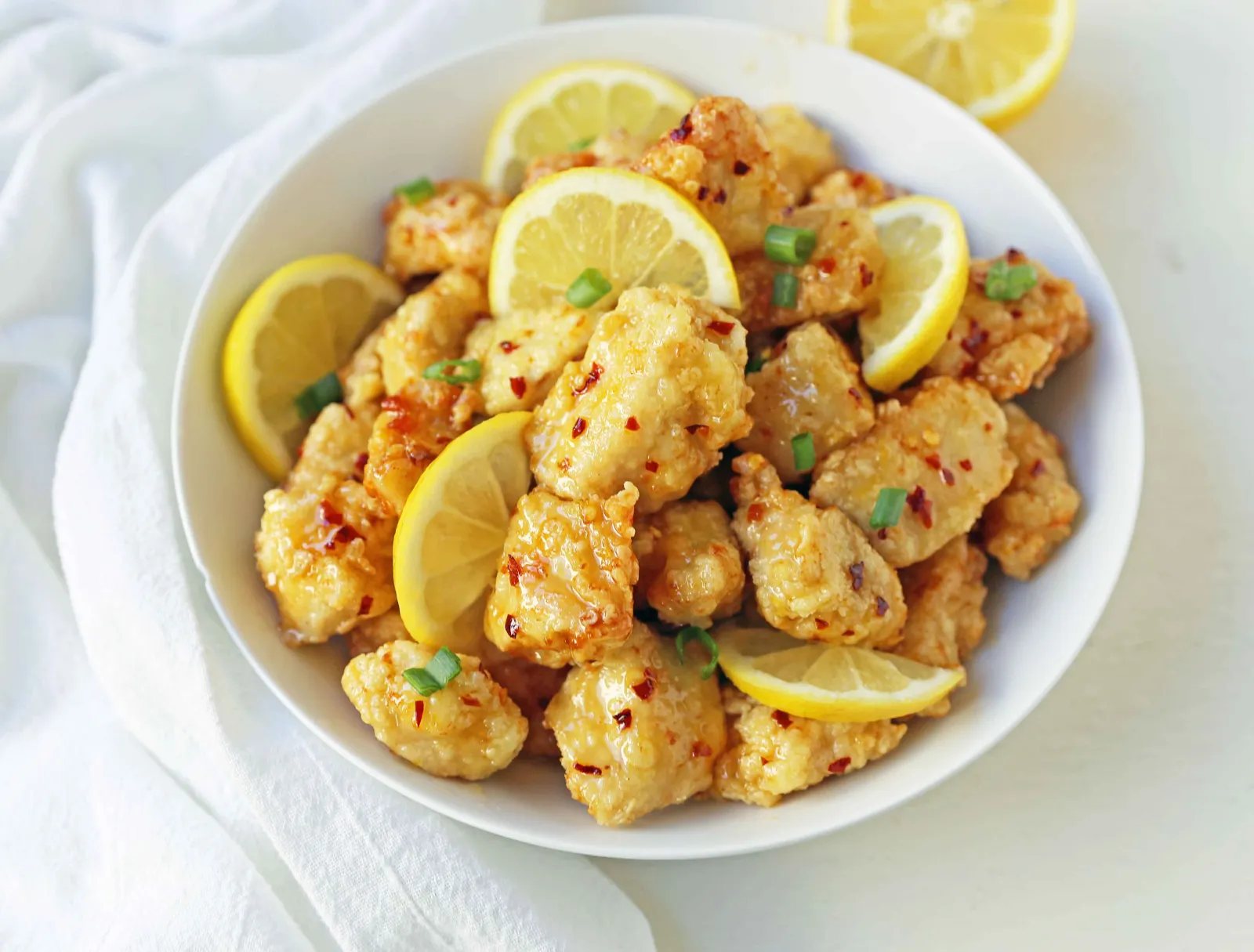 Chinese Lemon Chicken made with crispy fried chicken covered in an authentic, fresh lemon sauce. The ultimate Chinese Lemon Chicken Recipe which is way better than take-out. www.modernhoney.com #chinesefood #asianfood #lemonchicken #chineselemonchicken