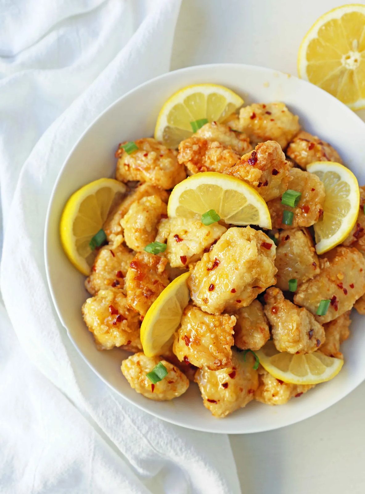 Chinese Lemon Chicken made with crispy fried chicken covered in an authentic, fresh lemon sauce. The ultimate Chinese Lemon Chicken Recipe which is way better than take-out. www.modernhoney.com #chinesefood #asianfood #lemonchicken #chineselemonchicken