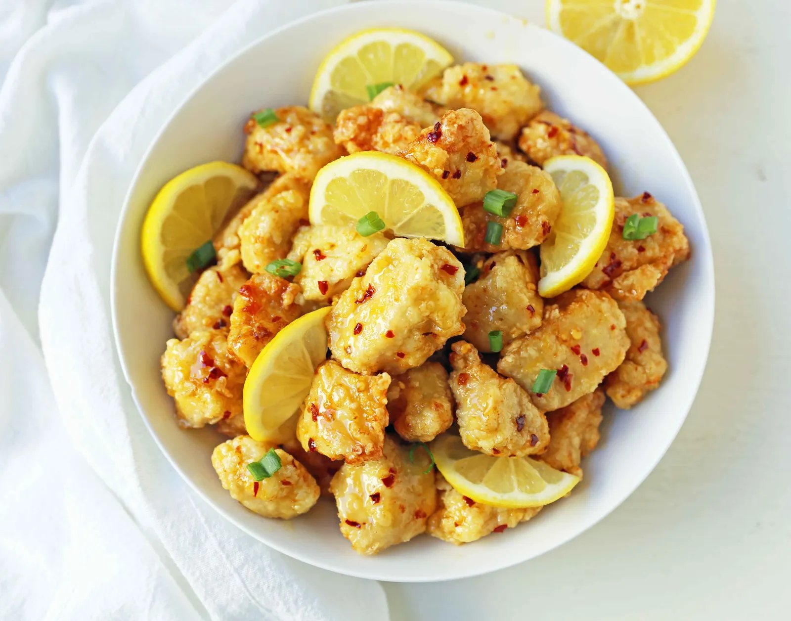 Chinese Lemon Chicken made with crispy fried chicken covered in an authentic, fresh lemon sauce. The ultimate Chinese Lemon Chicken Recipe which is way better than take-out. www.modernhoney.com #chinesefood #asianfood #lemonchicken #chineselemonchicken
