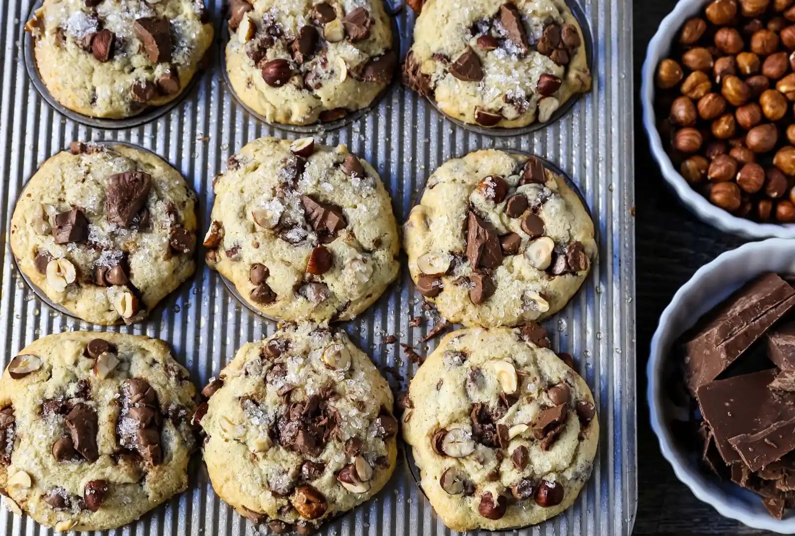 The Best Chocolate Chip Muffins. Chocolate Chunk Hazelnut Muffins with rich chocolate chips and crunchy hazelnuts. A gourmet bakery style muffin recipe. www.modernhoney.com #muffin #muffins #chocolatechipmmuffin #chocolatehazelnut