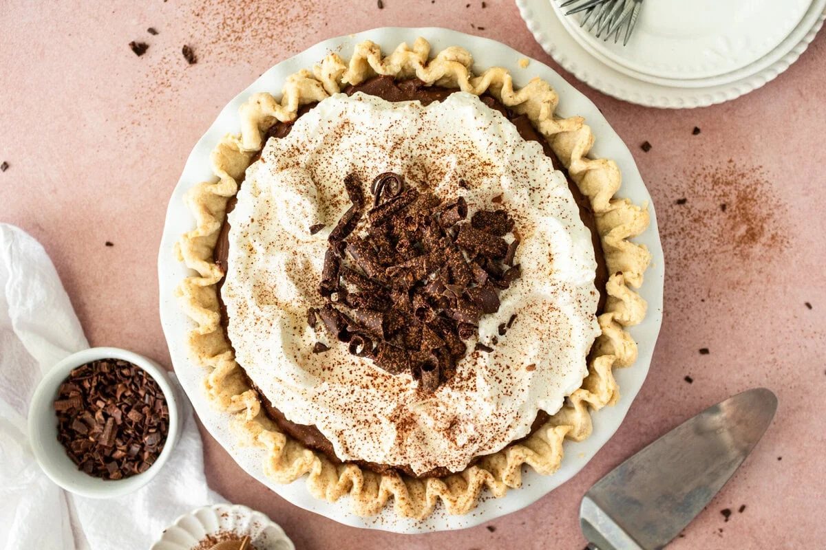 This is the best Chocolate Cream Pie recipe made with decadent chocolate custard in a flaky, buttery crust and topped with homemade whipped cream and chocolate shavings. You will love this chocolate pie recipe!