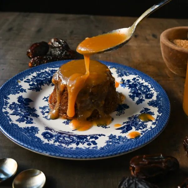 Sticky Toffee Pudding. A famous English dessert with a moist sponge cake covered in homemade caramel toffee sauce and vanilla ice cream. This is a beautiful Christmas dessert recipe.