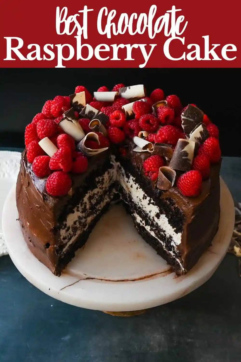 This is the Best Chocolate Raspberry Cake Recipe. Rich layered chocolate cake with whipped cream cheese raspberry filling, topped with creamy chocolate buttercream frosting and fresh raspberries.