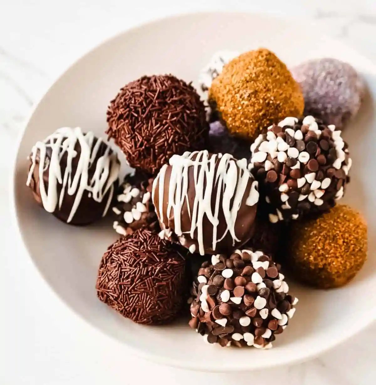 Chocolate Truffles. Rich, creamy, decadent homemade chocolate truffles made with high-quality chocolate, heavy cream, and a touch of butter rolled into your favorite toppings.