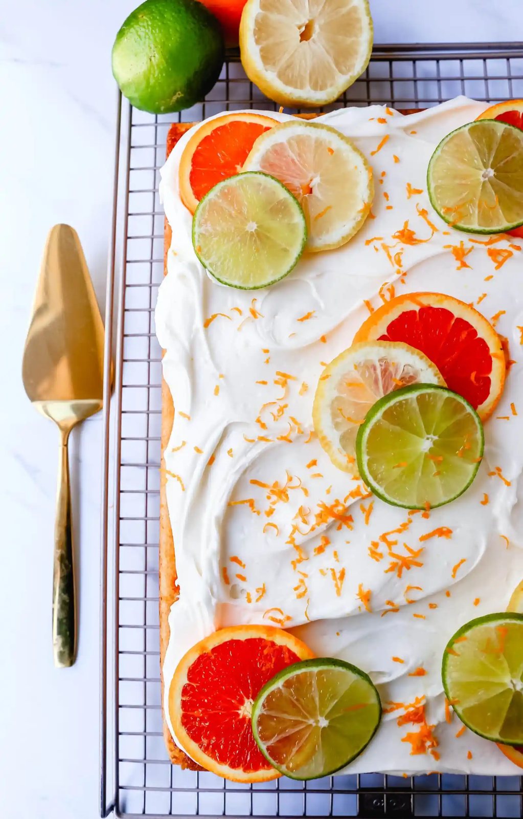 Citrus Sheet Cake made with fresh-squeezed orange, lemon, and lime juices in a moist, fluffy cake and topped with a creamy and silky homemade cream cheese frosting and topped with citrus slices. A beautiful Spring and Summer celebration cake!