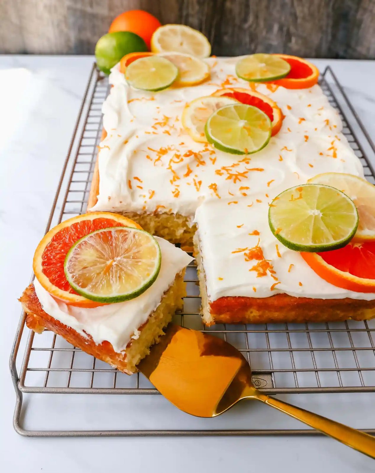 Citrus Sheet Cake made with fresh-squeezed orange, lemon, and lime juices in a moist, fluffy cake and topped with a creamy and silky homemade cream cheese frosting and topped with citrus slices. A beautiful Spring and Summer celebration cake!