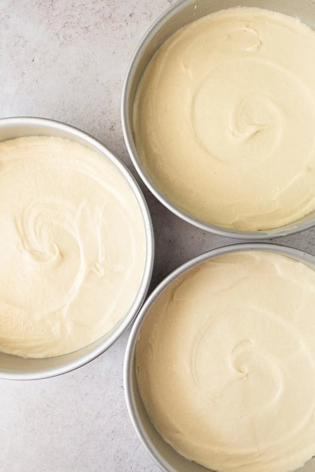 Coconut cake batter in three 8-inch cake pans for a 3-layer coconut cake.