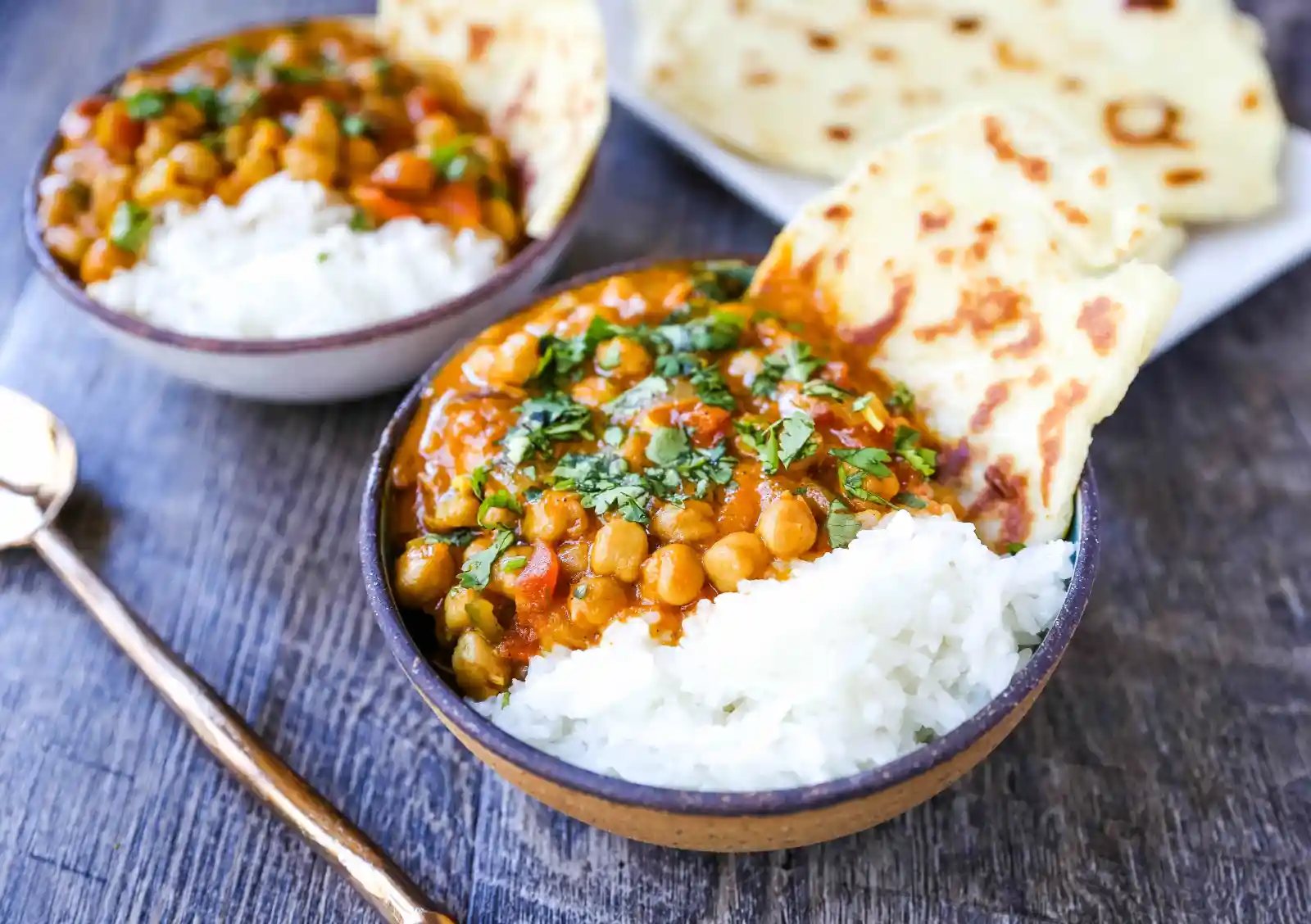 Coconut Chickpea Curry A rich coconut curry broth with onion, garlic, ginger, Indian spices in coconut milk and tossed with chickpeas. Flavorful vegan meal and you won't even miss the meat! www.modernhoney.com #vegan #curry #indianfood #vegancurry #chickpeacurry