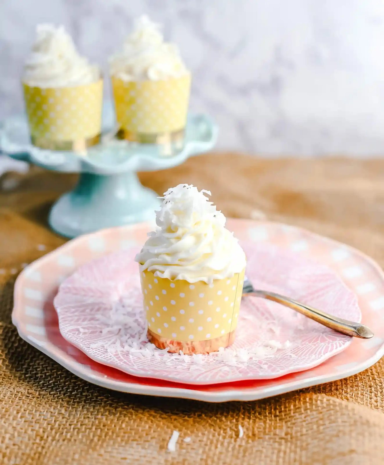Coconut Cupcakes Moist coconut cupcakes with a secret ingredient to keep them extra soft and tender with a sweet coconut cream cheese frosting. www.modernhoney.com #coconutcupcakes #cupcakes #cupcake #coconutcupcake