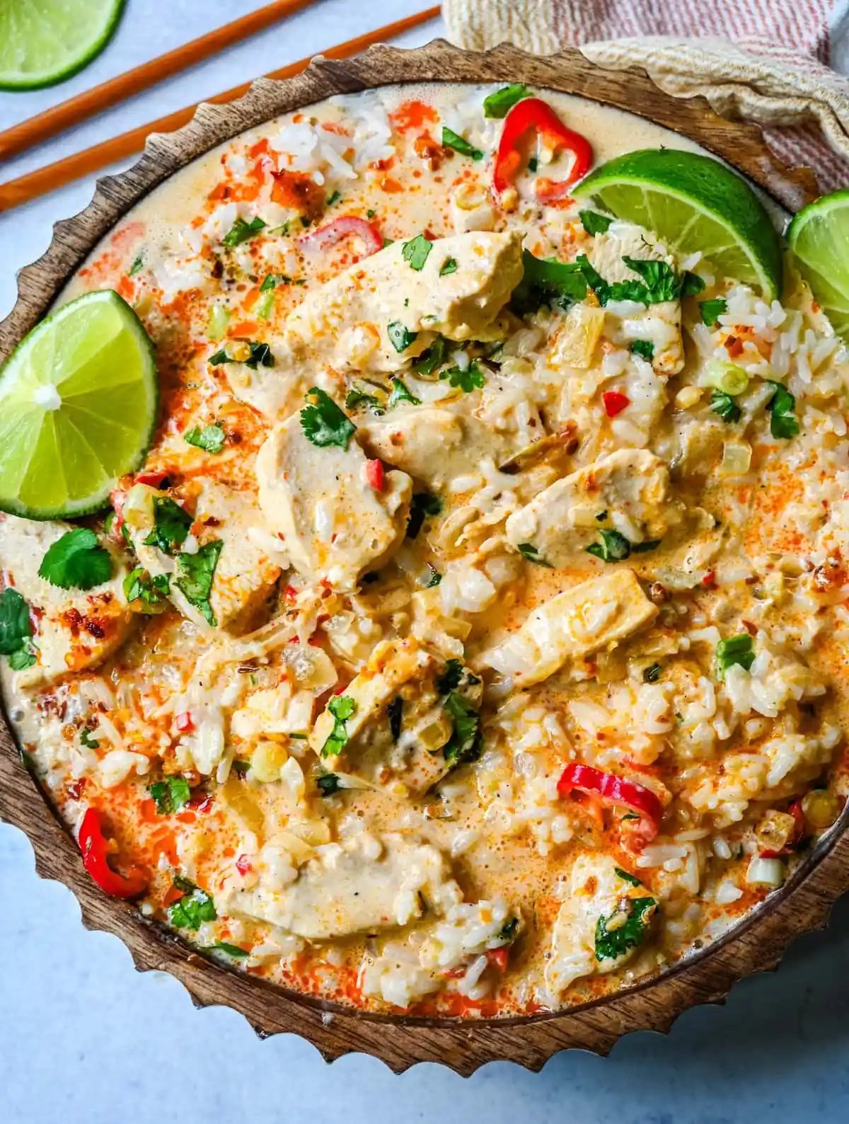 This tender Poached Coconut Milk Chicken with aromatics, creamy coconut milk, red Thai curry paste, and spices all atop rice is made in less than 30 minutes and is perfect for a weeknight dinner.