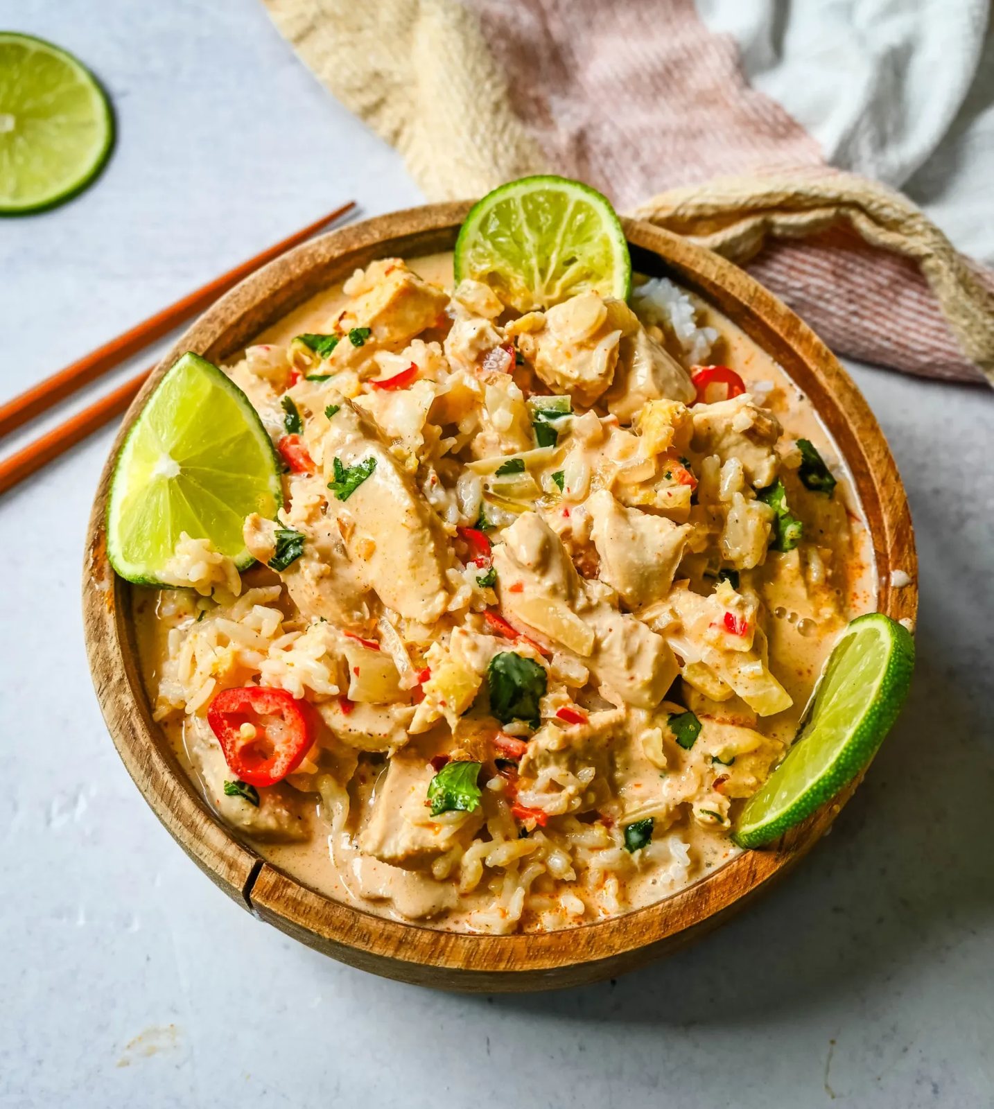 This tender Poached Coconut Milk Chicken with aromatics, creamy coconut milk, red Thai curry paste, and spices all atop rice is made in less than 30 minutes and is perfect for a weeknight dinner.