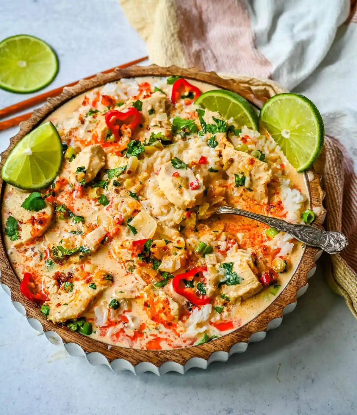 This tender Poached Coconut Milk Chicken with aromatics, creamy coconut milk, red Thai curry paste, and spices all atop rice is made in less than 30 minutes and is perfect for a weeknight dinner.