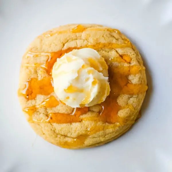 Turn your favorite cornbread into a cookie! These soft cornbread cookies have crisp golden edges, a tender cornmeal crumb, and whipped honey butter on top. Better than Crumbl!