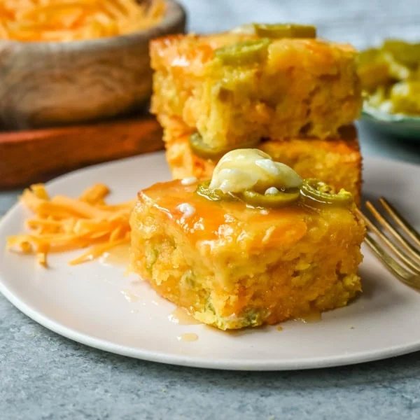 This Homemade Jalapeno Cheddar Cornbread is golden, cheesy, spicy, and just a little sweet, and is the ultimate upgrade from basic boxed cornbread. It has a moist, fluffy center amd layered with sharp cheddar cheese and jalapenos for the perfect Jalapeno Cheddar Cornbread recipe.