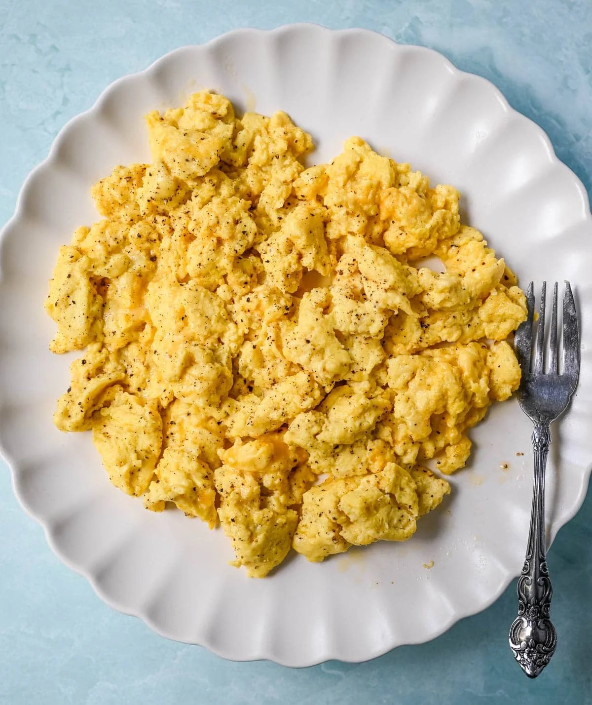 These Cottage Cheese Scrambled Eggs are the creamiest, fluffiest scrambled eggs you'll ever make — with over 20g of protein per serving! Learn the simple technique, the best mix-ins, and every tip for perfect scrambled eggs every time.