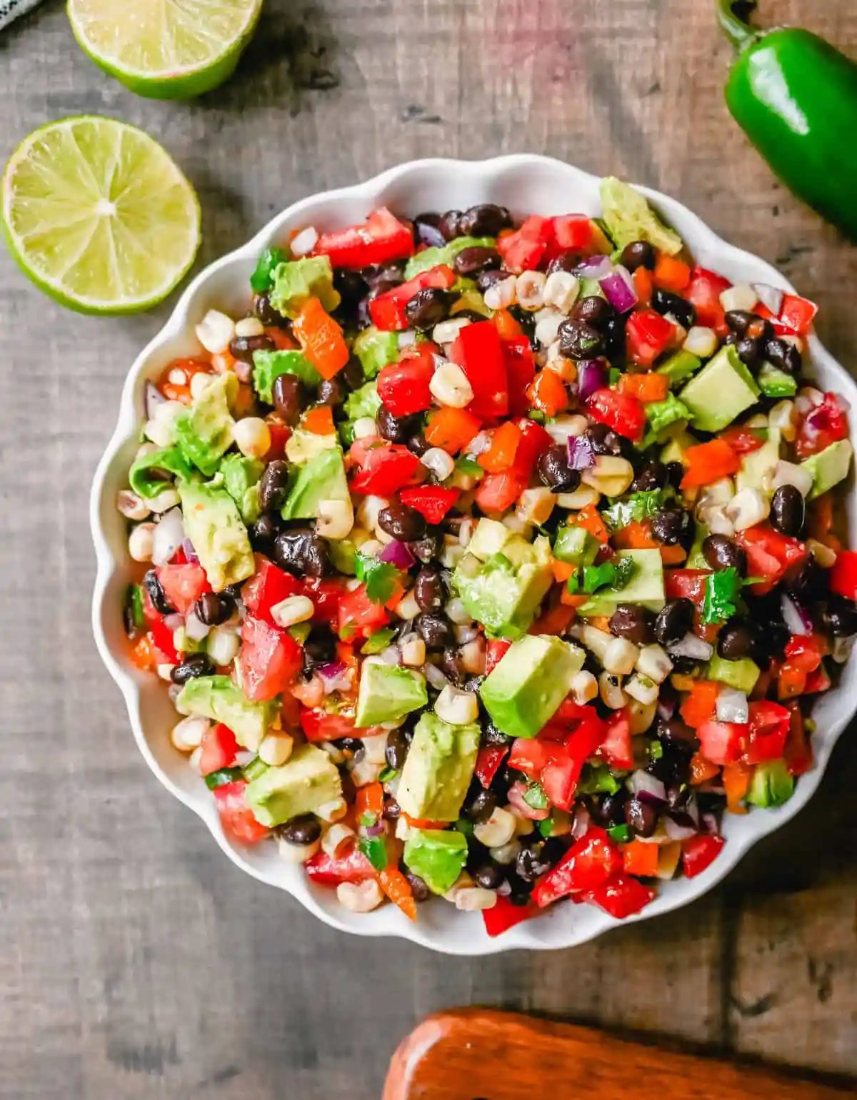 Cowboy Caviar. A popular, crowd-pleasing, fresh salsa appetizer made with black beans, corn, tomatoes, cilantro, avocado, peppers, all tossed in a zesty dressing.