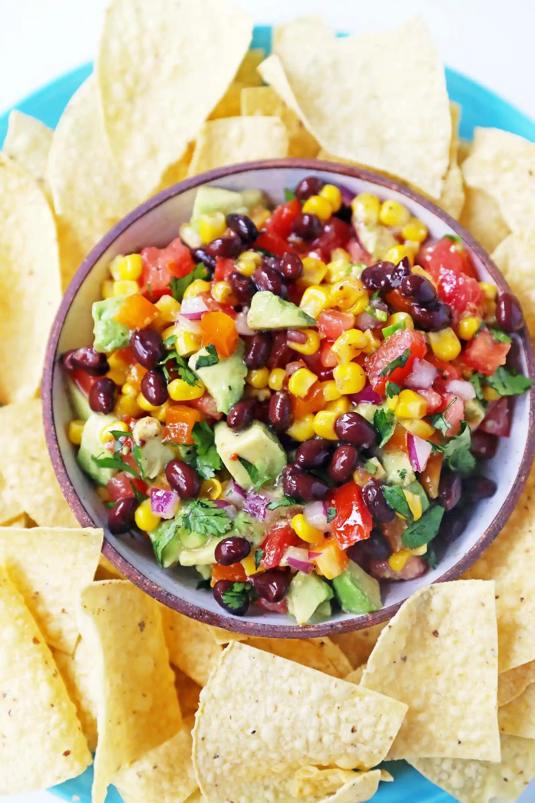 Cowboy Caviar. A popular, crowd-pleasing appetizer made with black beans, corn, tomatoes, cilantro, avocado, peppers, all tossed in a zesty dressing. www.modernhoney.com #cowboycaviar #appetizer #salsa #cornsalsa #blackbeansalsa #appetizers