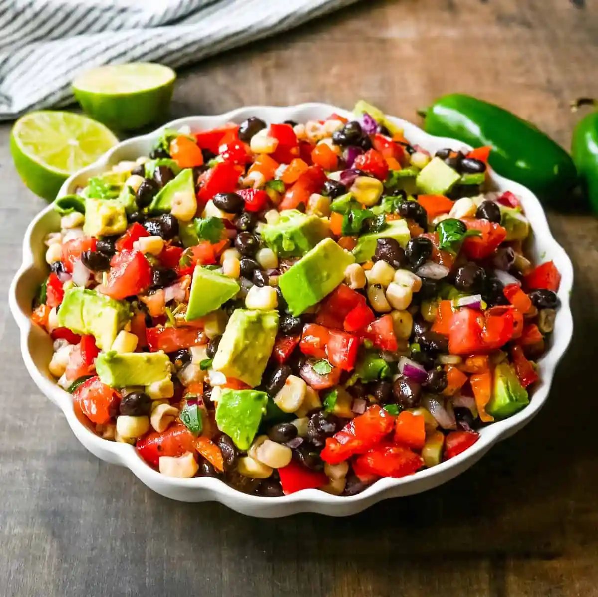 Cowboy Caviar. A popular, crowd-pleasing, fresh salsa appetizer made with black beans, corn, tomatoes, cilantro, avocado, peppers, all tossed in a zesty dressing.