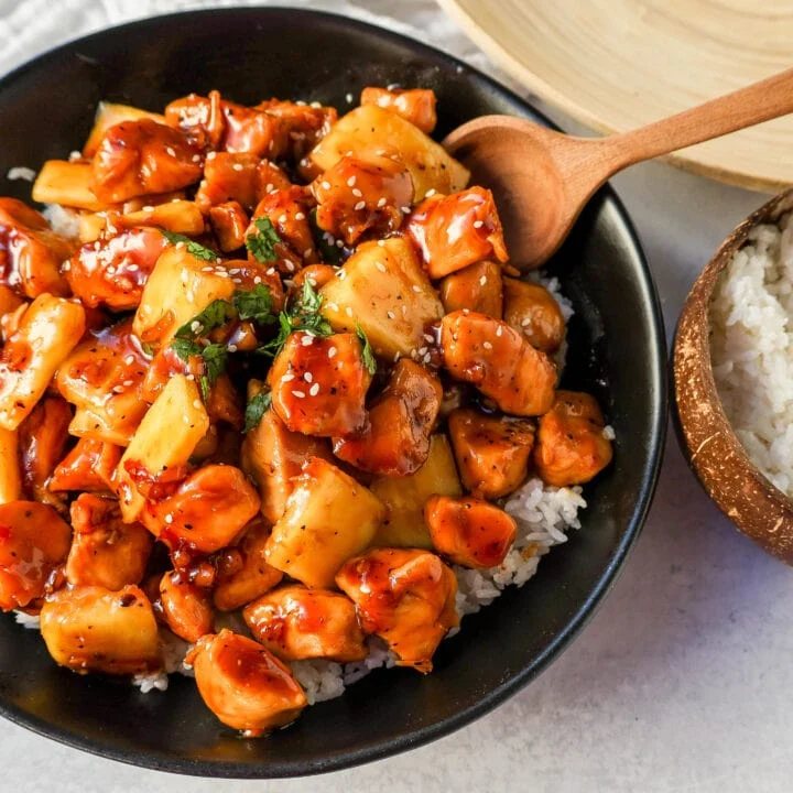 This Sticky Pineapple Chicken is made with chicken tossed in pineapple juice, sweet chili sauce, soy sauce, brown sugar, ginger, and fresh pineapple. This Hawaiian Chicken is perfectly sweet and sticky!