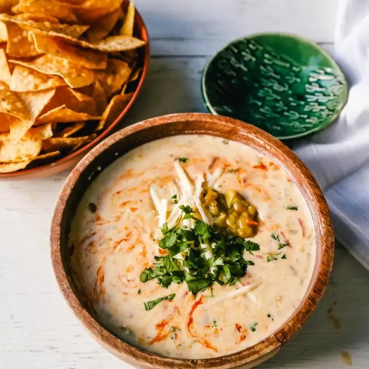 Queso Dip. Creamy green chile queso blanco dip made with the perfect blend of cheeses, green chiles, fresh cilantro, and hot sauce. How to make the perfect homemade queso! #queso #cincodemayo #mexican #mexicanfood