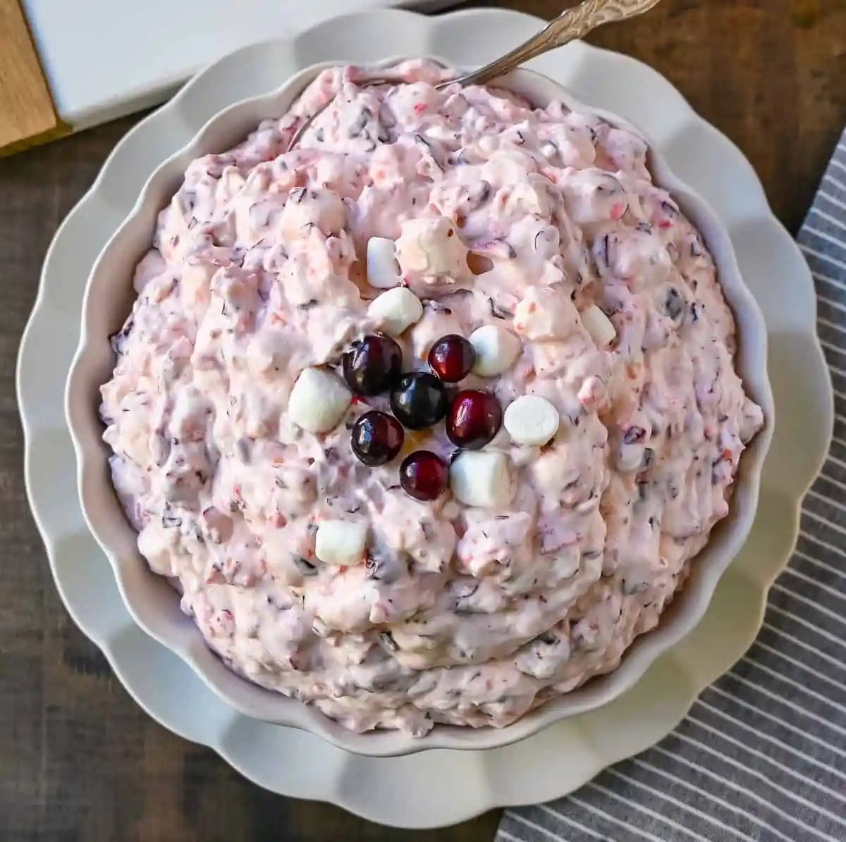Cranberry Fluff Salad. This is such a popular holiday side dish! This easy cranberry salad is made with fresh cranberries, fresh pineapple, mini marshmallows, cream cheese, sugar, and fresh whipped cream. Perfectly sweet, tart, and creamy. This classic side dish recipe has been modernized and is better than ever!