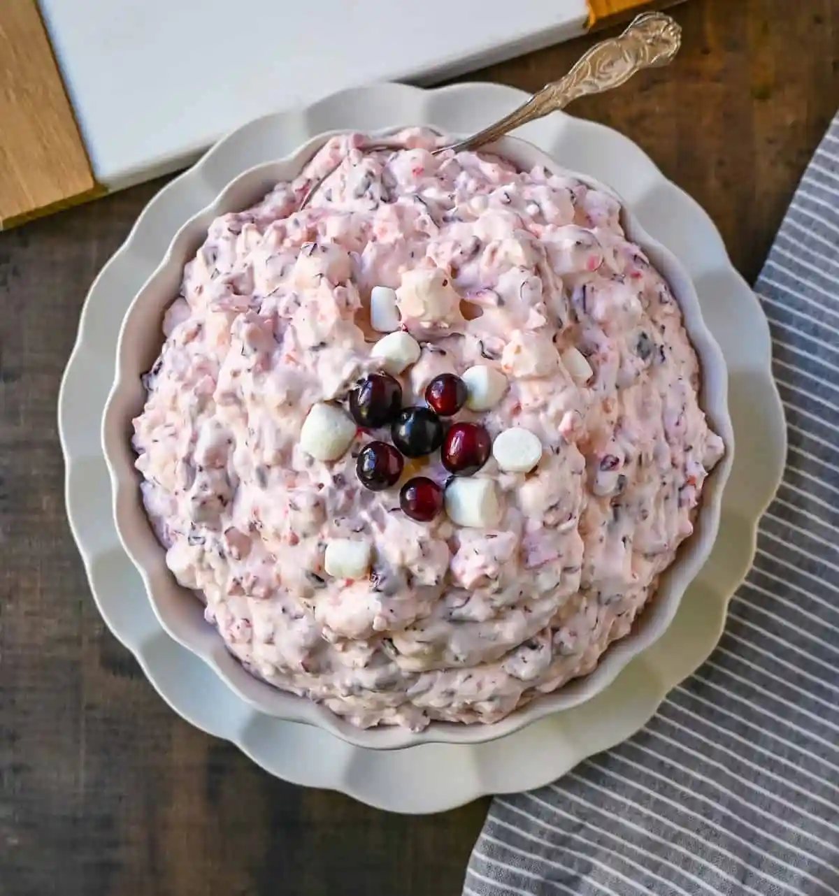 Cranberry Fluff Salad. This is such a popular holiday side dish! This easy cranberry salad is made with fresh cranberries, fresh pineapple, mini marshmallows, cream cheese, sugar, and fresh whipped cream. Perfectly sweet, tart, and creamy. This classic side dish recipe has been modernized and is better than ever!