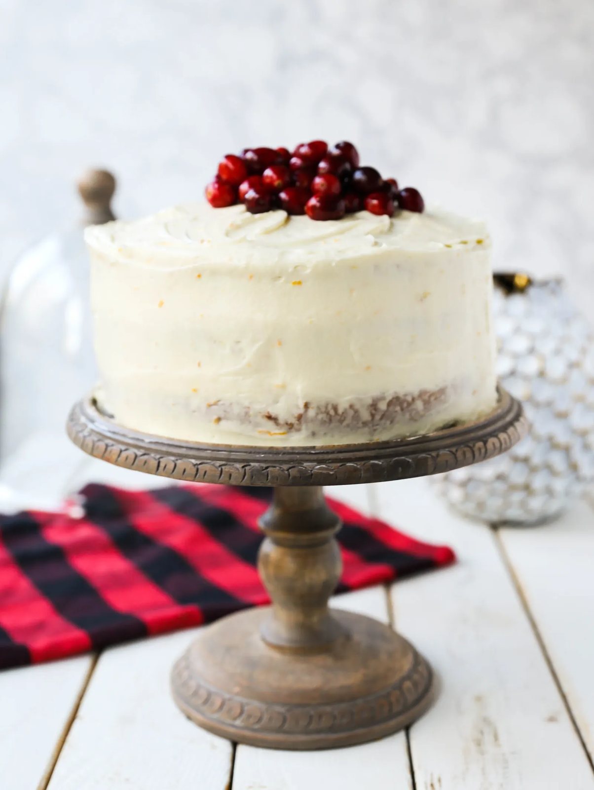 Cranberry Orange Cake. A moist orange zest cake with fresh cranberries with a sweet cream cheese orange frosting. A sweet yet tart holiday cake. www.modernhoney.com #cranberry #cranberrycake #cranberryorange #cranberryorangecake
