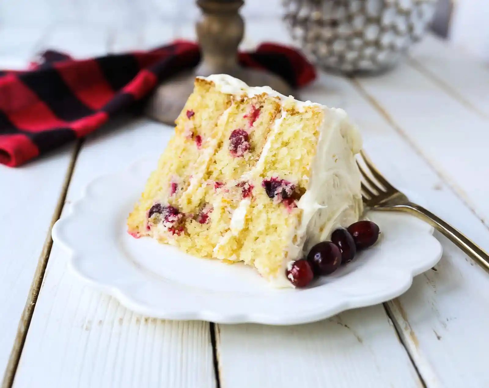 Cranberry Orange Cake. A moist orange zest cake with fresh cranberries with a sweet cream cheese orange frosting. A sweet yet tart holiday cake. www.modernhoney.com #cranberry #cranberrycake #cranberryorange #cranberryorangecake