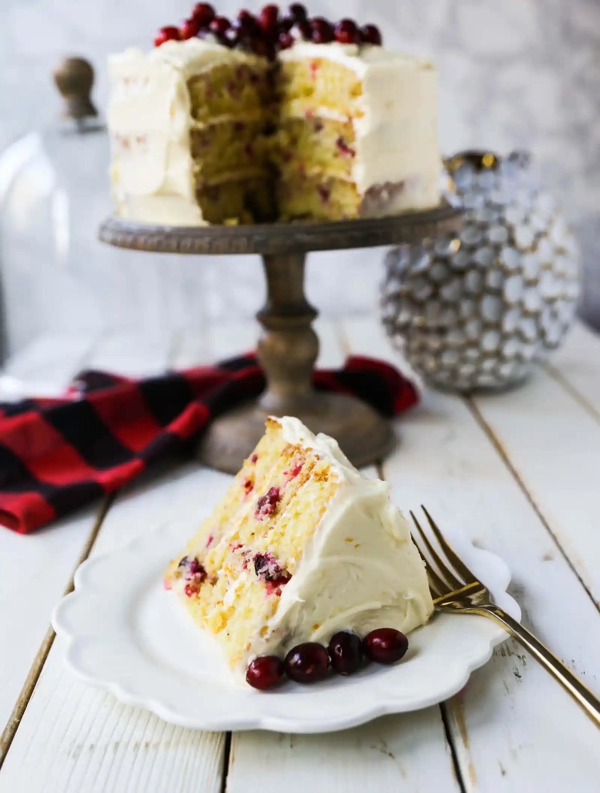 Cranberry Orange Cake. A moist orange zest cake with fresh cranberries with a sweet cream cheese orange frosting. A sweet yet tart holiday cake. www.modernhoney.com #cranberry #cranberrycake #cranberryorange #cranberryorangecake