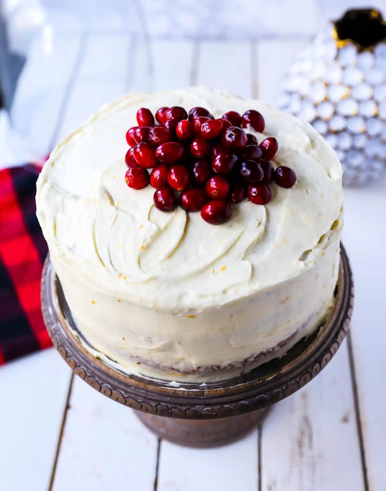 Cranberry Orange Cake. A moist orange zest cake with fresh cranberries with a sweet cream cheese orange frosting. A sweet yet tart holiday cake. www.modernhoney.com #cranberry #cranberrycake #cranberryorange #cranberryorangecake